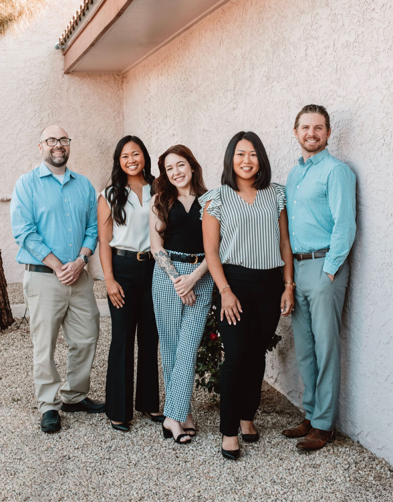 Arizona insurance consultants posing outside of office building